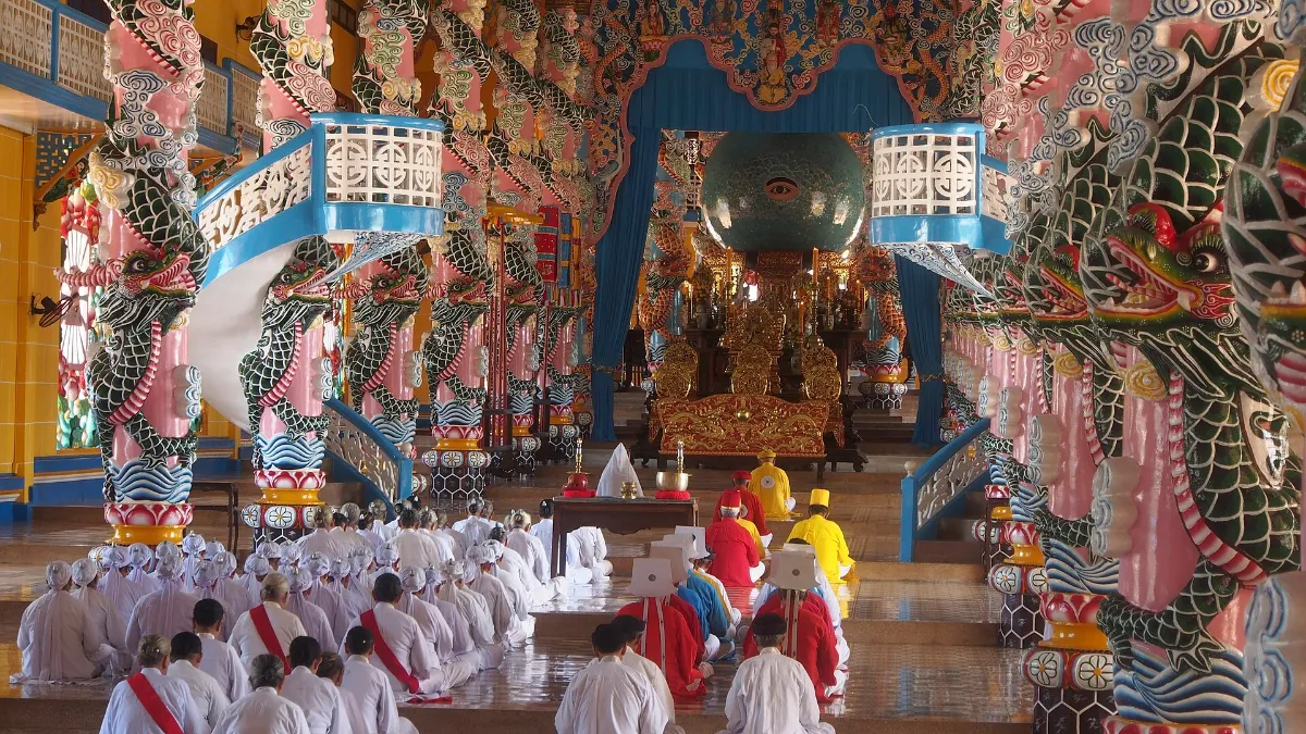 Interior of the Cao Dai Temple in Tay Ninh with dragon columns and the Divine Eye