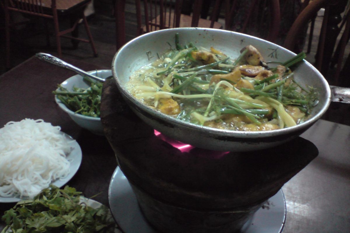 Cha ca: turmeric fish sizzling in a pan with dill and spring onions, served with rice noodles