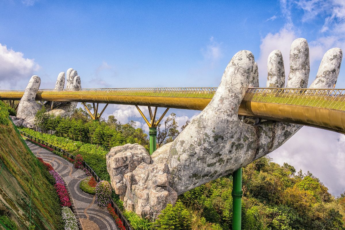 The Golden Bridge held by giant stone hands at Ba Na Hills, Da Nang
