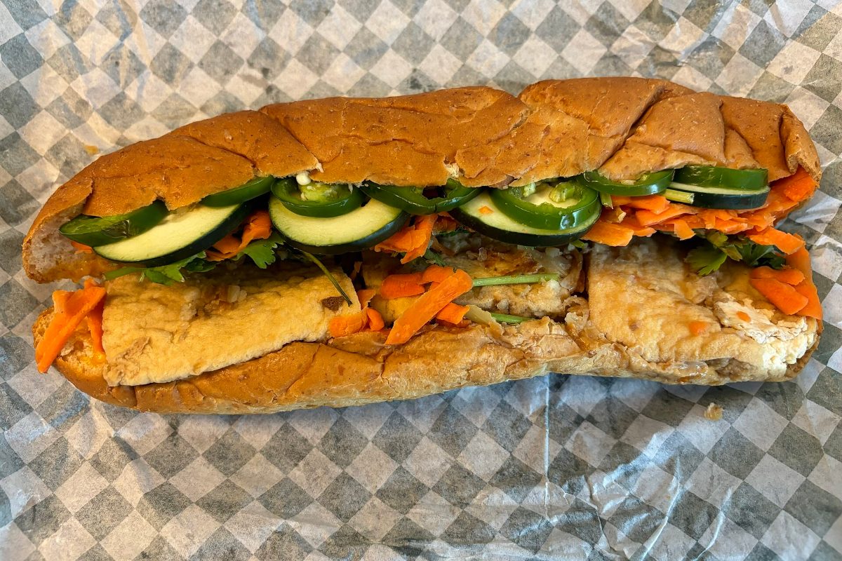 Vietnamese banh mi baguette sandwich filled with tofu, cucumber, pickled carrot and chilli