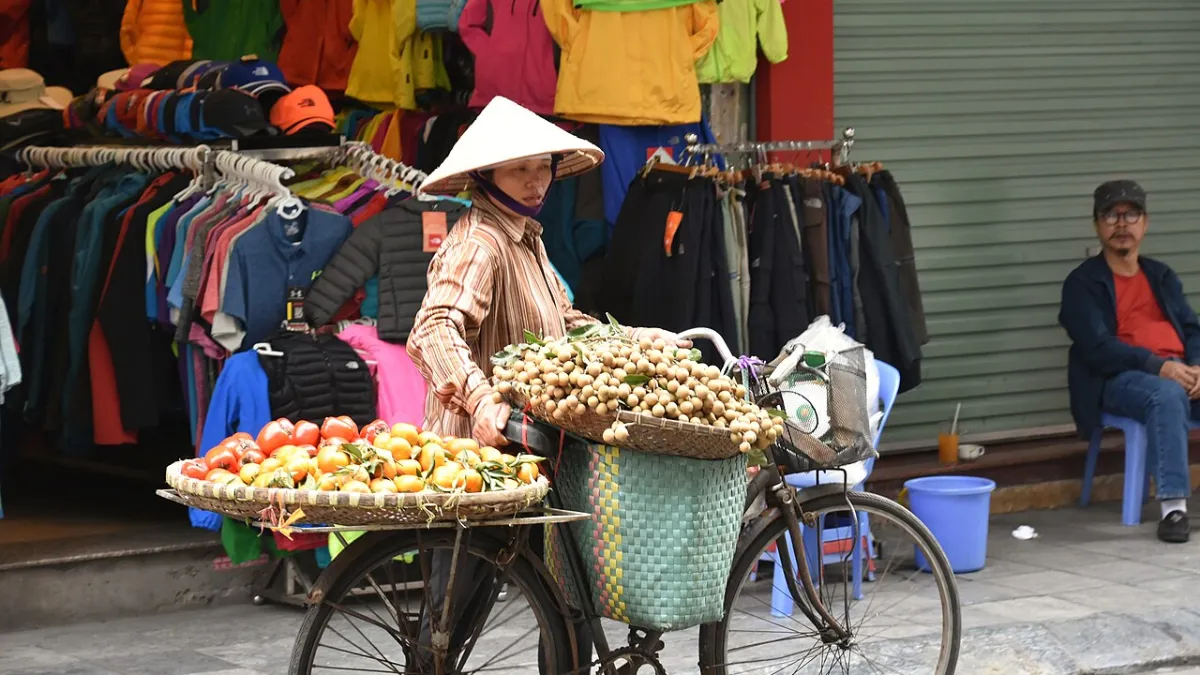 Street vendor with a shoulder pole in Hanoi Old Quarter