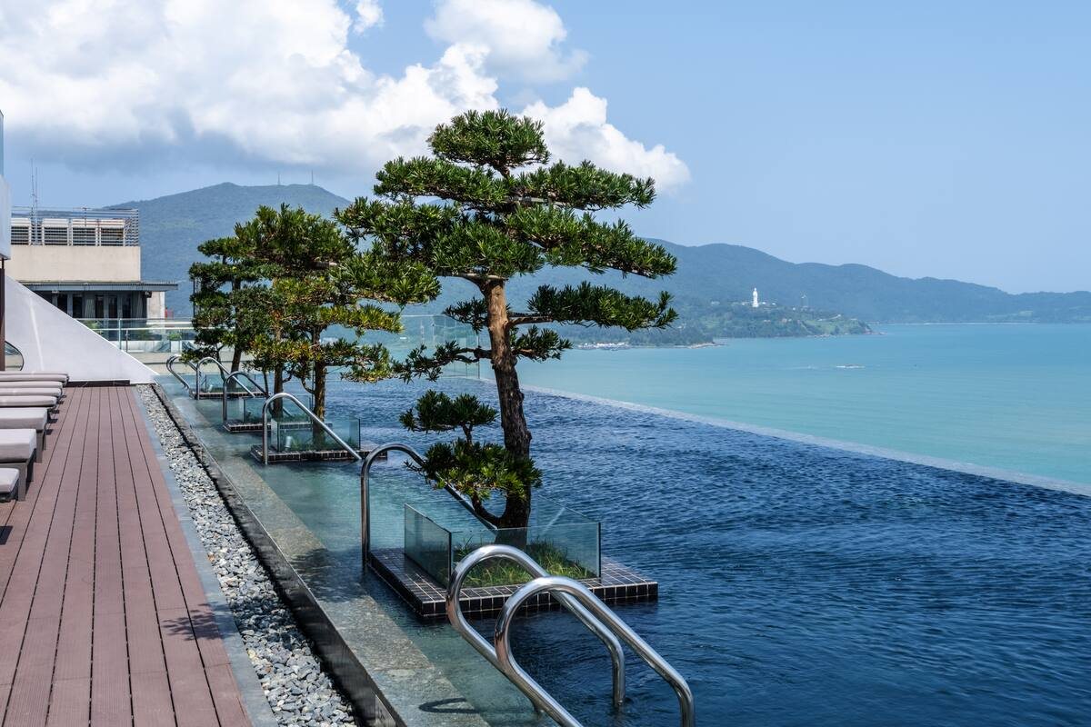 Rooftop infinity pool with a view of the Son Tra peninsula at Hilton Garden Inn Da Nang