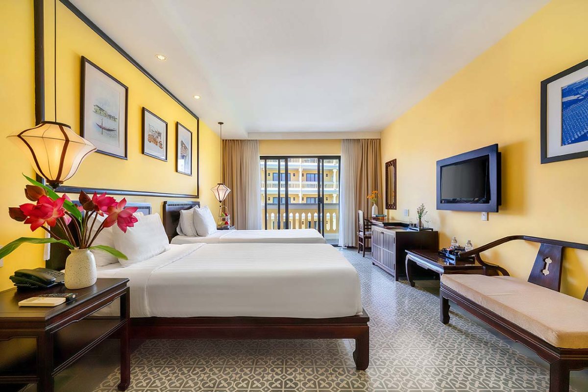 Bed in the Deluxe Room at Hoi An Central Boutique Hotel