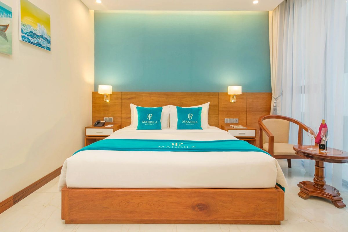 King bed in the Deluxe King room at Mandila Beach Hotel