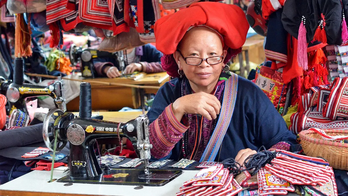 Red Dao woman sewing traditional embroidery in northern Vietnam