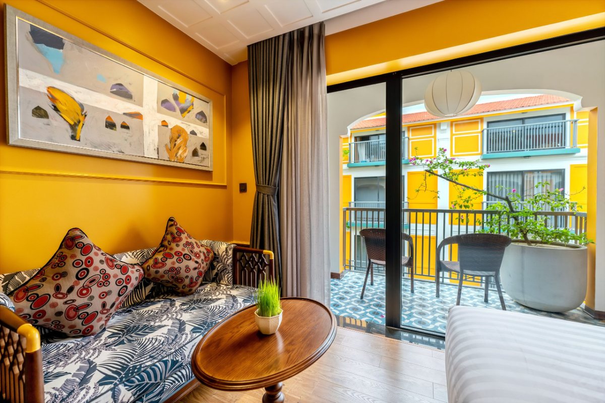 Room seating area by the balcony at Son Hoi An Boutique Hotel