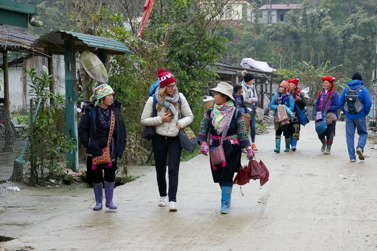 Trekkers with Hmong guides walking to Y Linh Ho village near Sapa