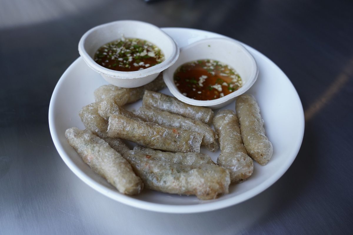 Plate of crispy Vietnamese fried spring rolls (nem ran) with dipping sauce