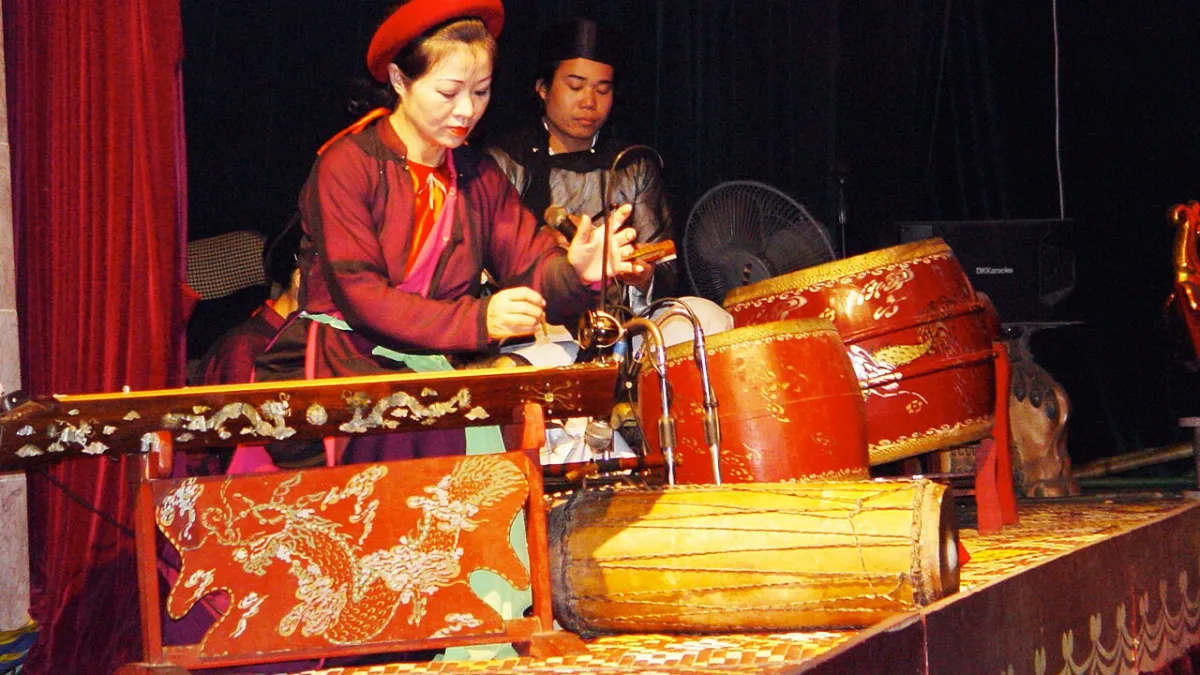 Traditional musicians playing live at a water puppet show